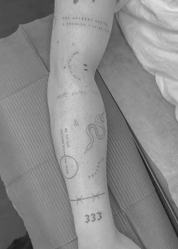 Snake tattoo with script text elements on forearm by Chelsea.Q